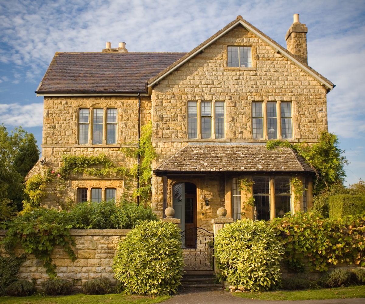 A honey-coloured Cotswolds stone home with mullioned windows, the kind of residential conveyance Davis Gregory handles weekly.